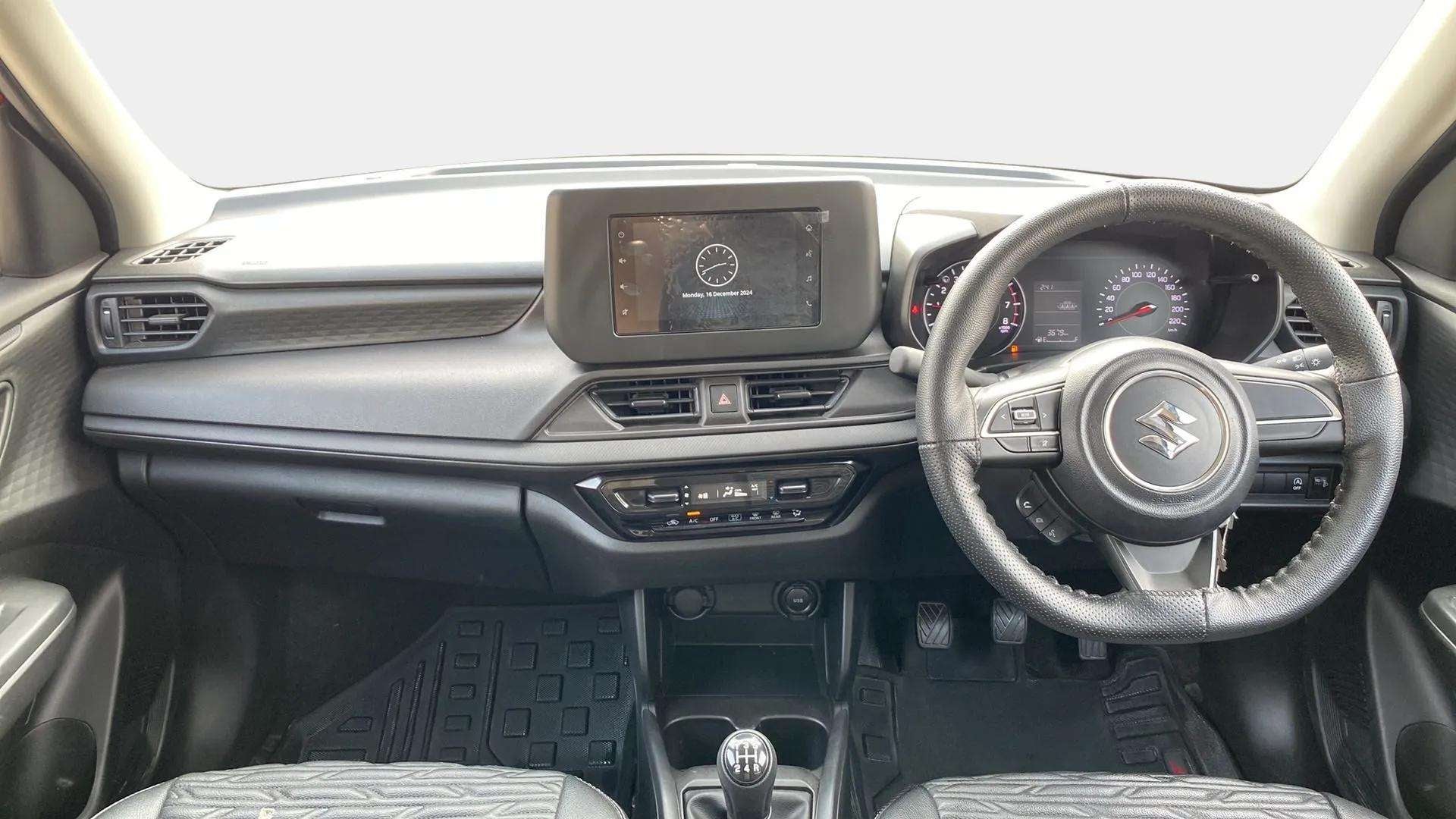 Interior dashboard view of a Maruti Suzuki Swift