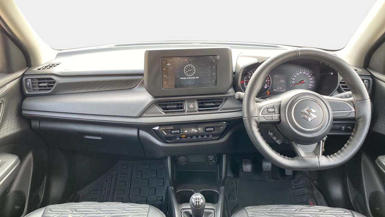 Interior dashboard view of a Maruti Suzuki Swift