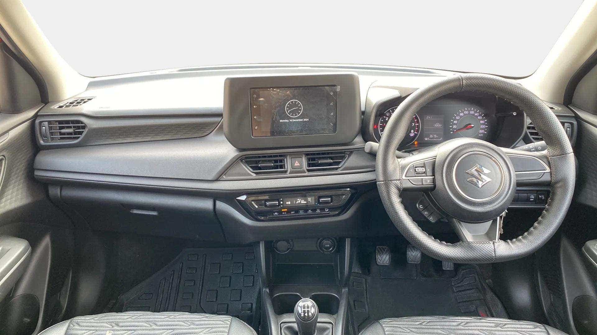 Interior dashboard view of a Maruti Suzuki Swift