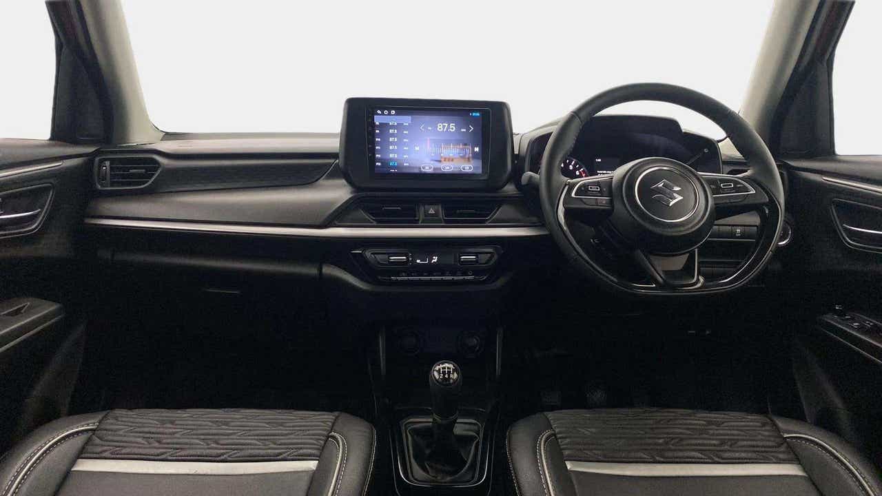 Dashboard and steering wheel of a Maruti Suzuki Swift