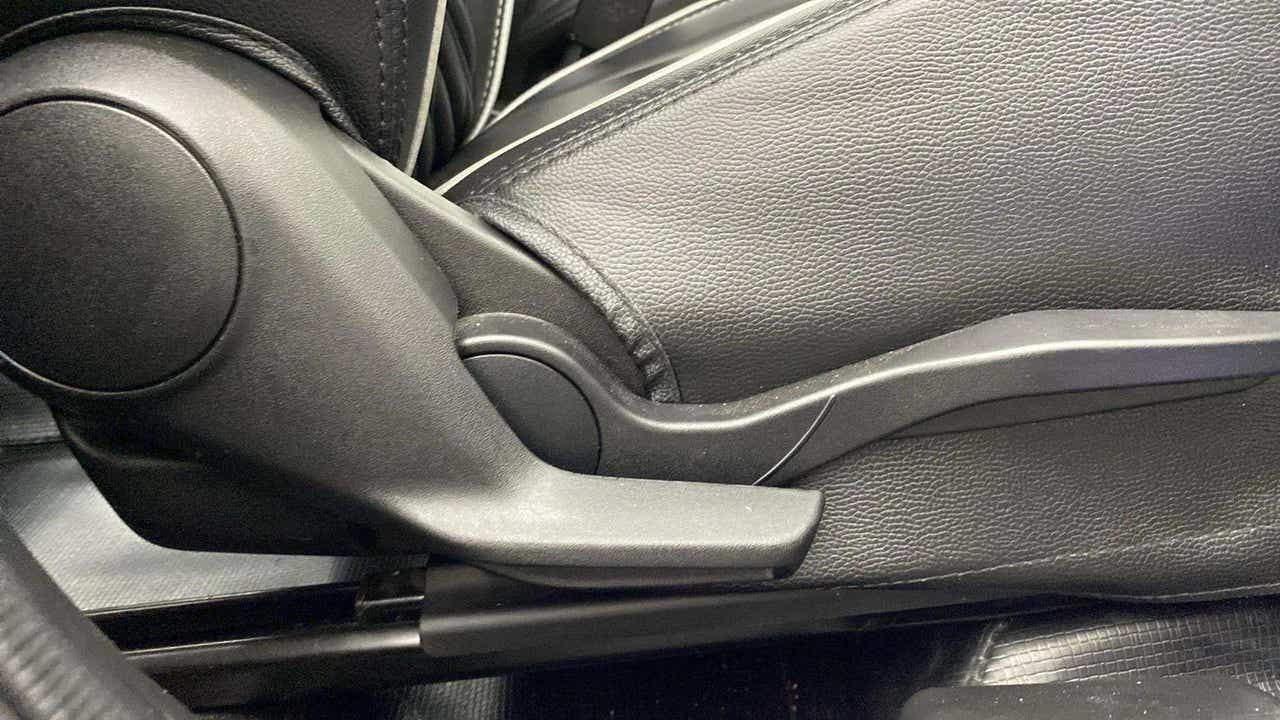 Close-up of a seat adjuster lever of a Maruti Suzuki Swift