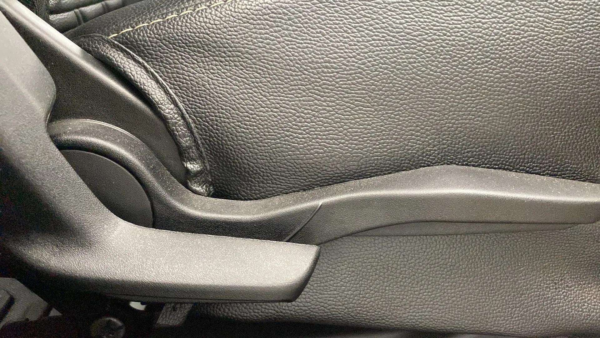 Close-up view of a Maruti Suzuki Swift car seat adjustment lever