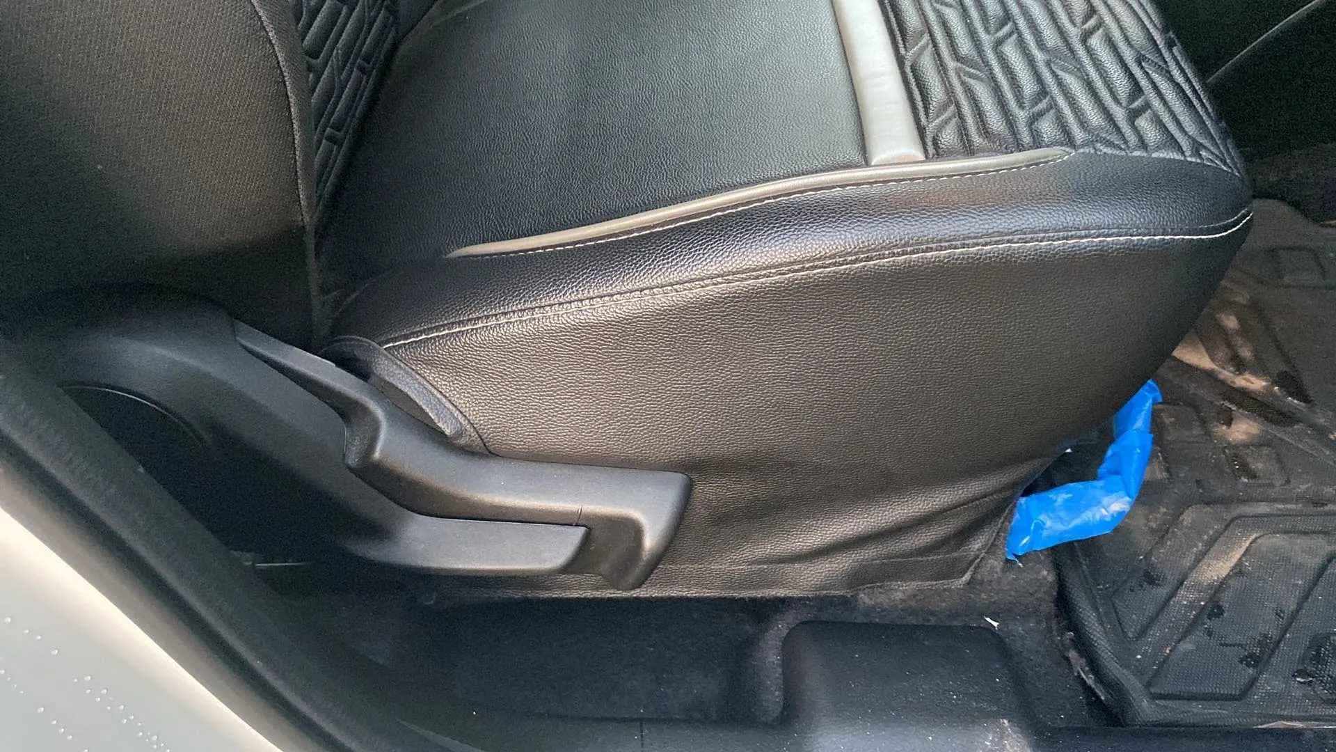 Close-up of front seat adjustment lever of a Maruti Suzuki Swift
