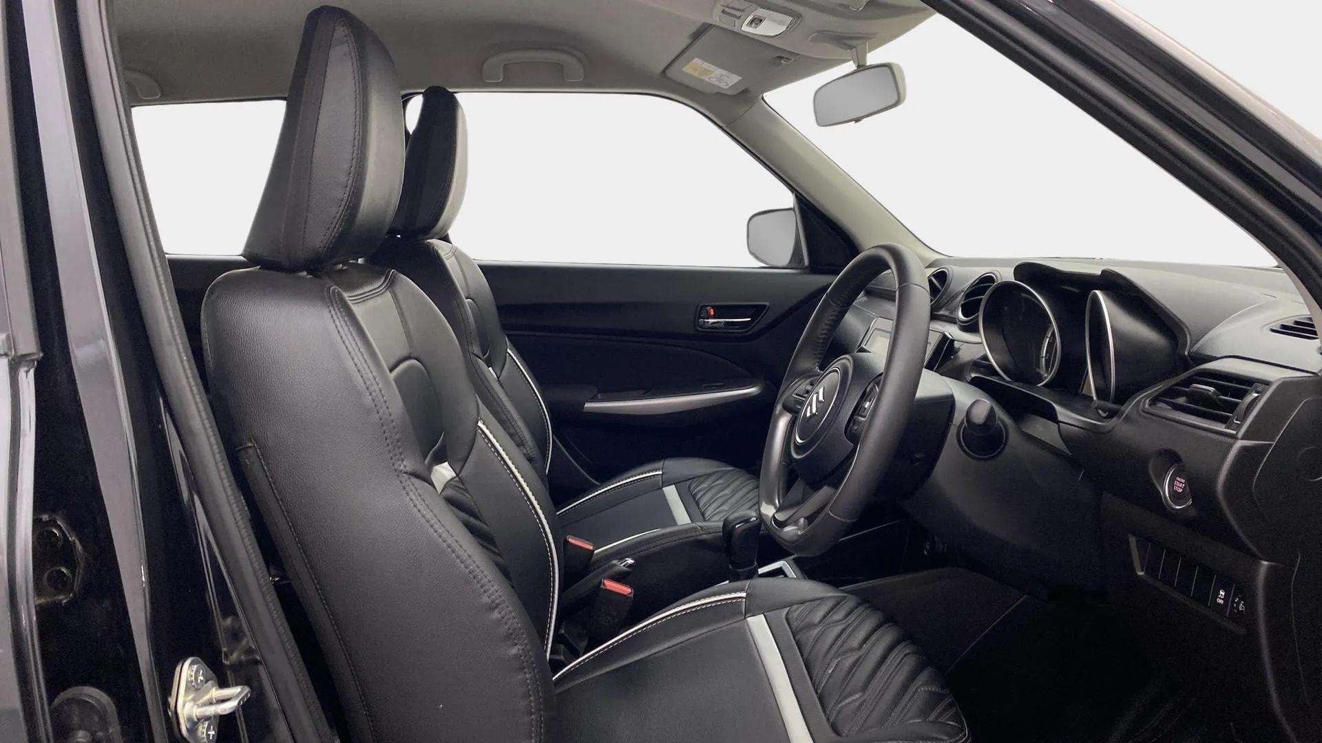 Interior front seats and dashboard of a Maruti Suzuki Swift