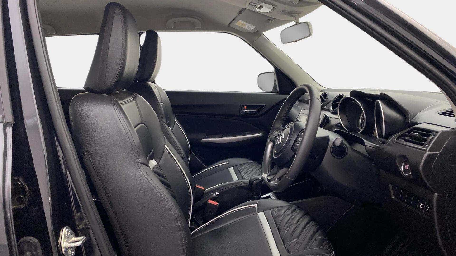 Interior front seats and dashboard of a Maruti Suzuki Swift