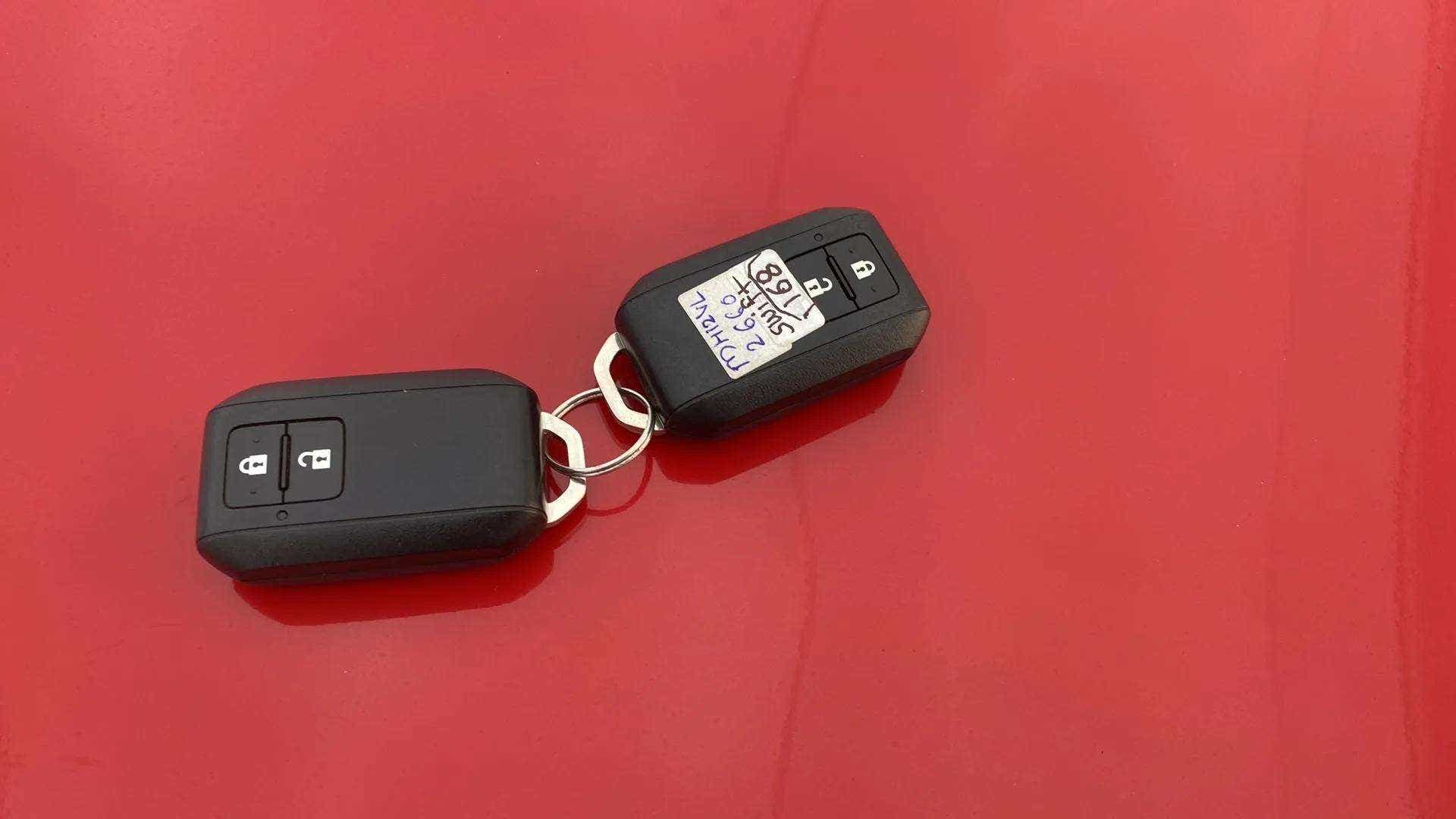 Car keys on the hood of a Maruti Suzuki Swift 2021 - 2023