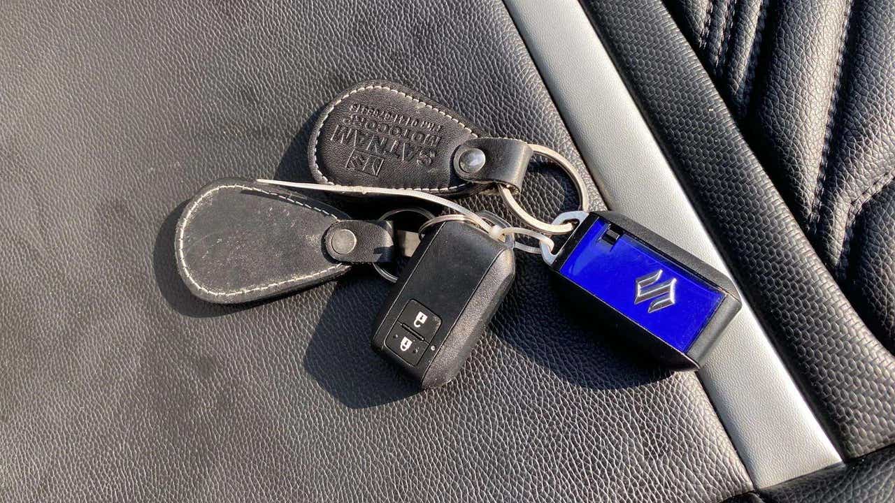 Car key fob and Maruti Suzuki Swift key on a leather seat