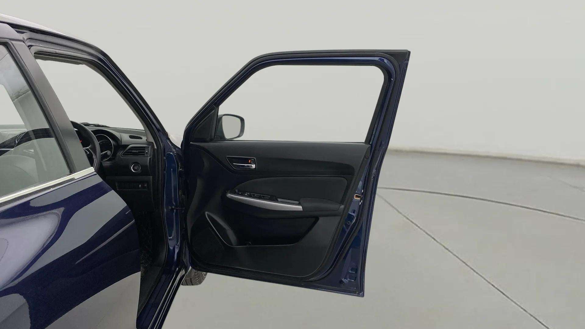 Front driver side door open view of a Maruti Suzuki Swift