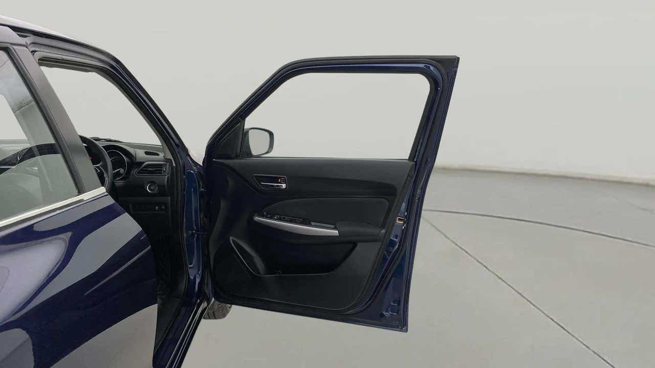 Front driver side door open view of a Maruti Suzuki Swift