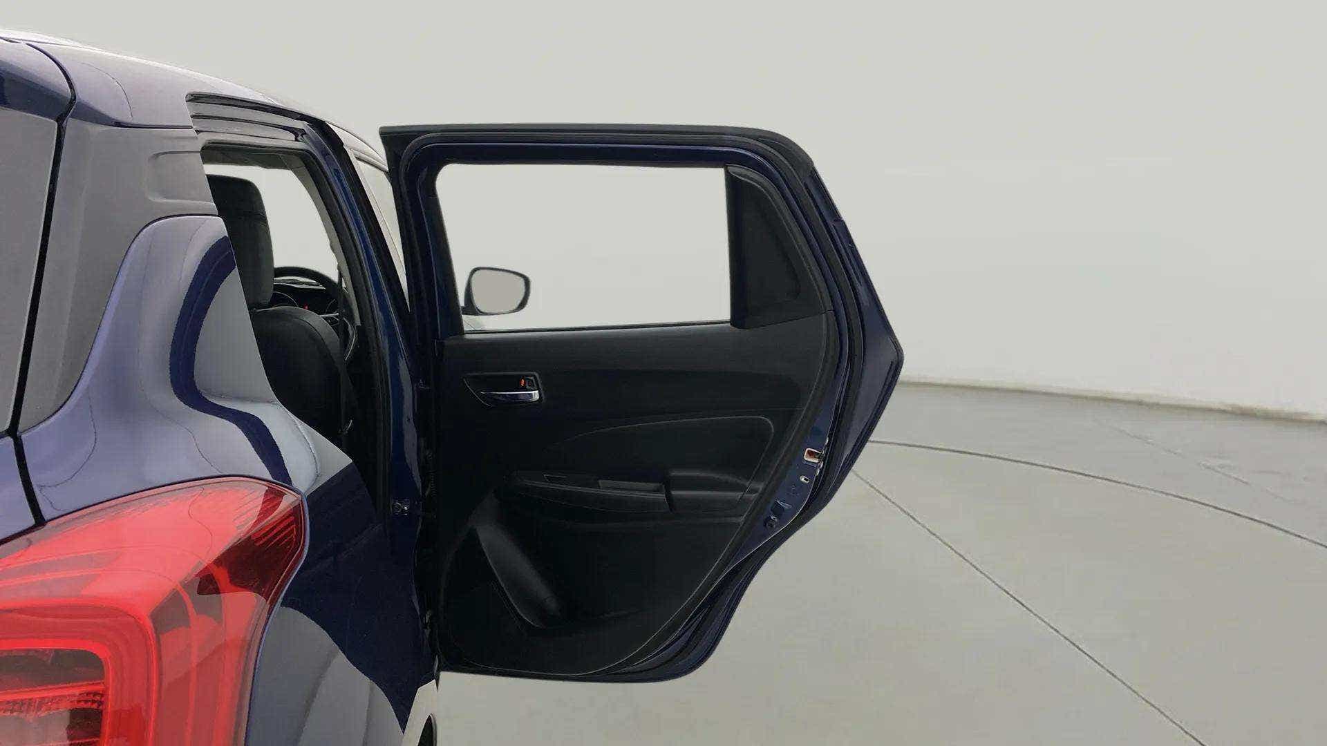 Rear left door open view of a Maruti Suzuki Swift