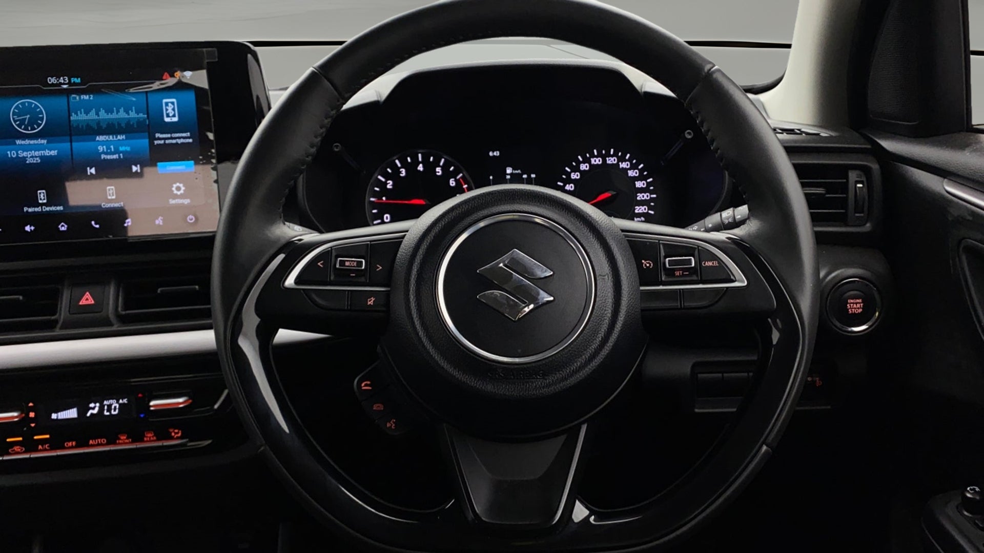 Interior dashboard and steering wheel of a Maruti Suzuki Swift