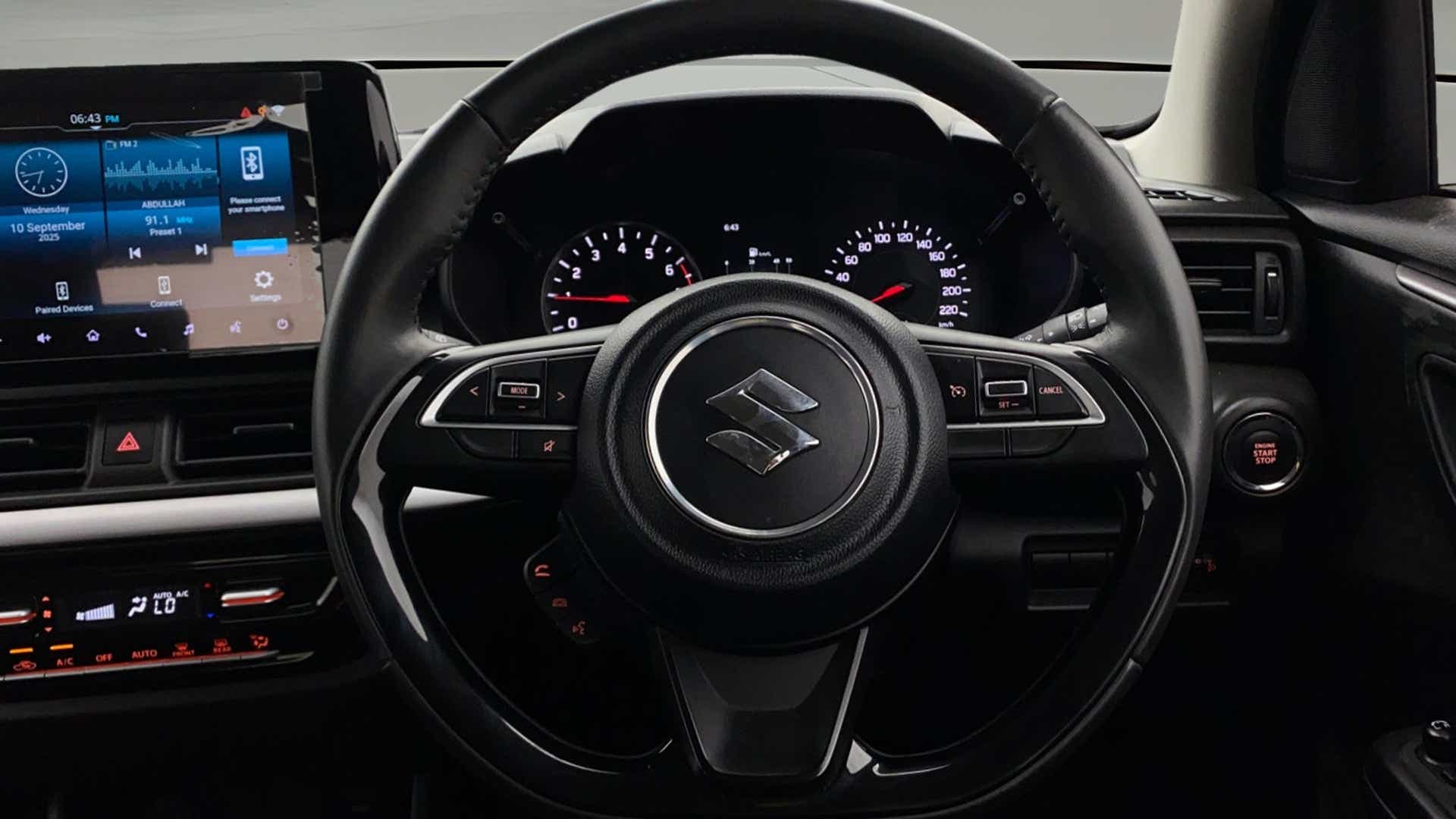 Interior dashboard and steering wheel of a Maruti Suzuki Swift
