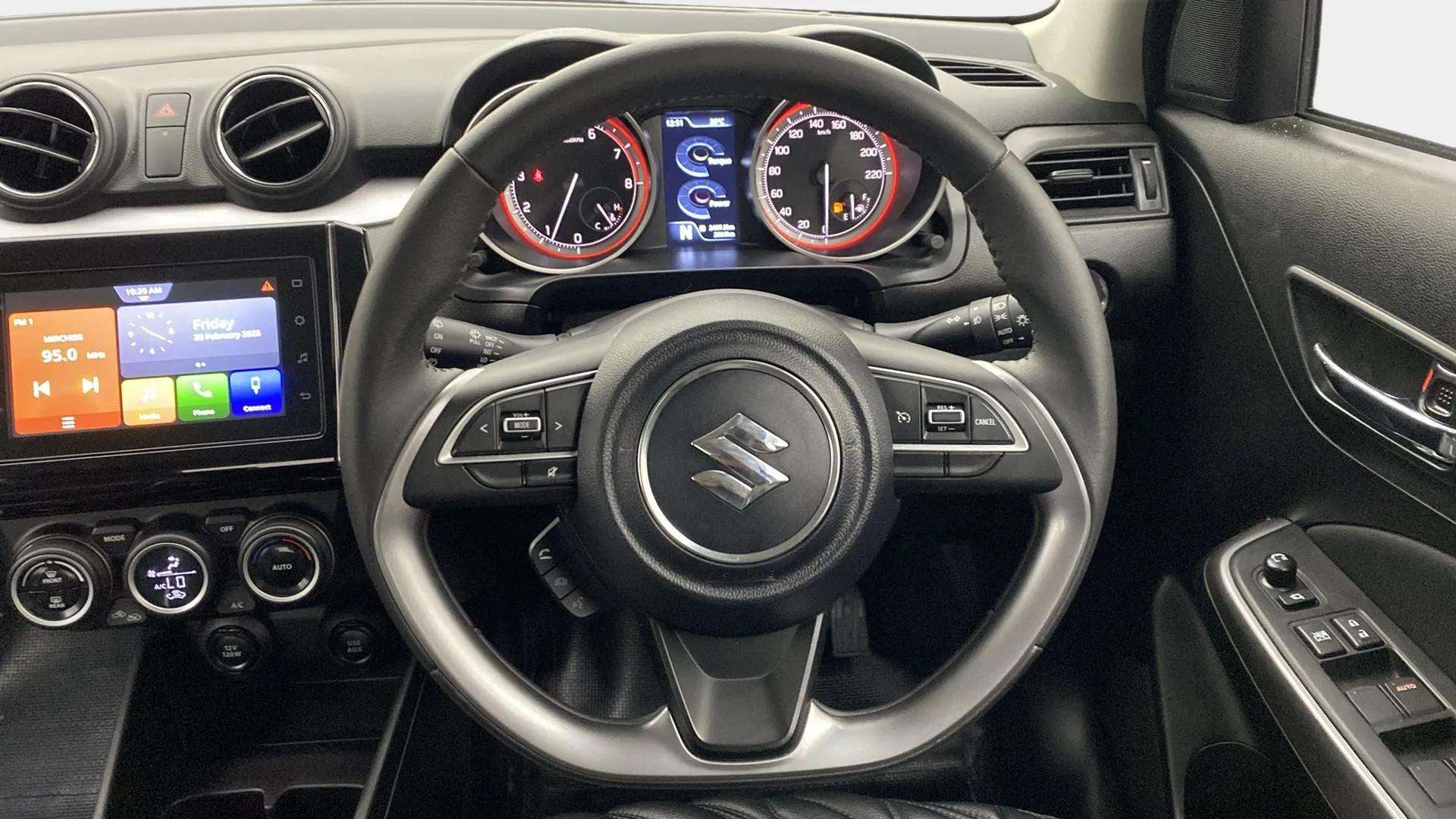 Interior dashboard view of a Maruti Suzuki Swift
