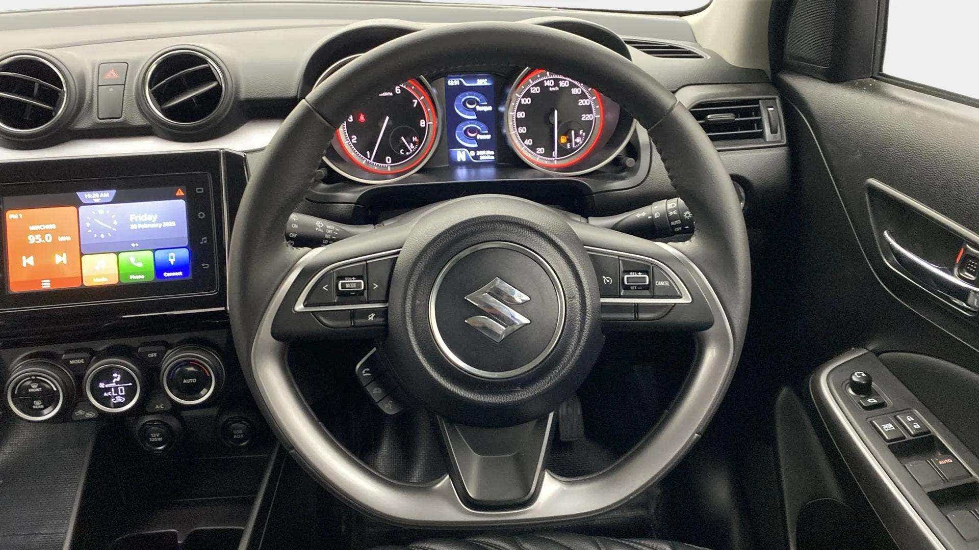 Interior dashboard view of a Maruti Suzuki Swift
