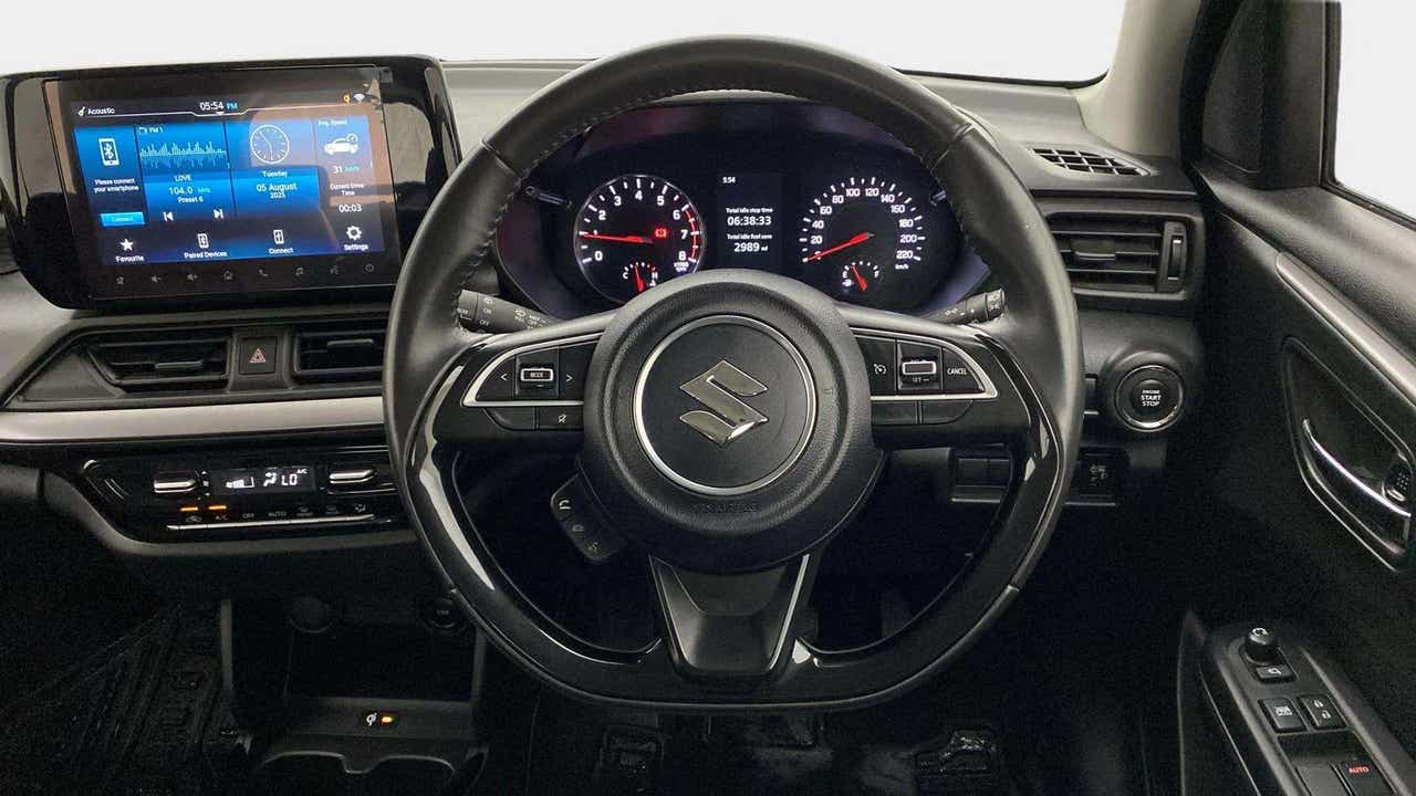 Interior dashboard view of a Maruti Suzuki Swift