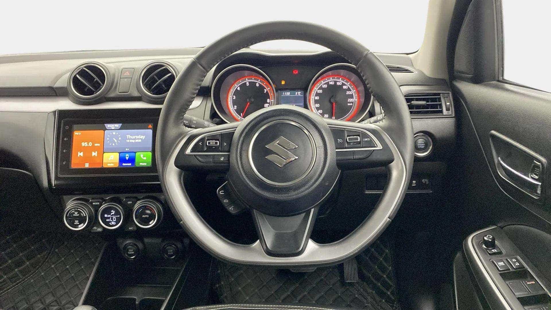 Dashboard and steering wheel of a Maruti Suzuki Swift