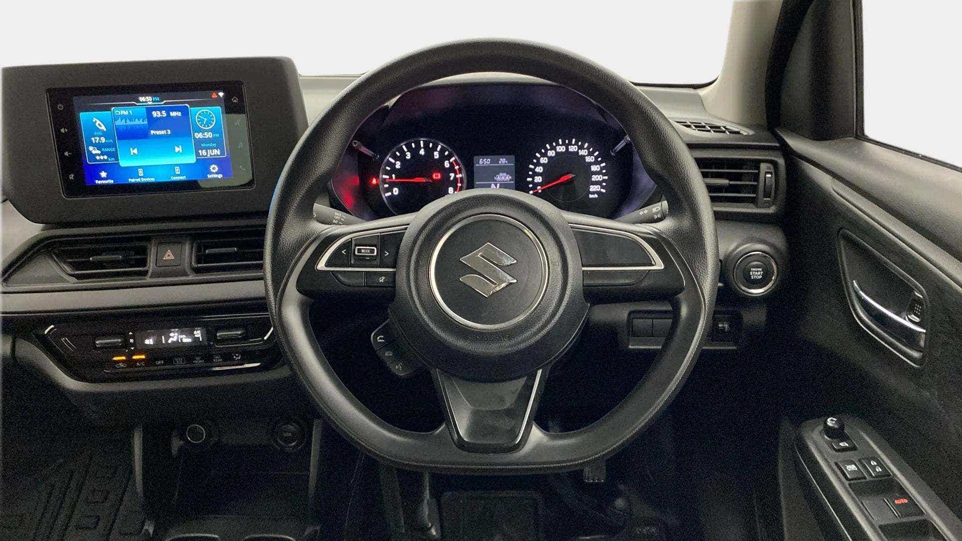 Dashboard and steering wheel of a Maruti Suzuki Swift