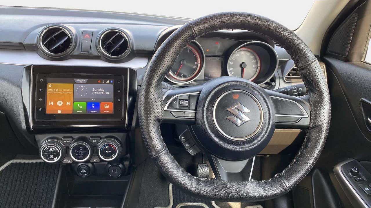 Interior dashboard and steering wheel of a Maruti Suzuki Swift