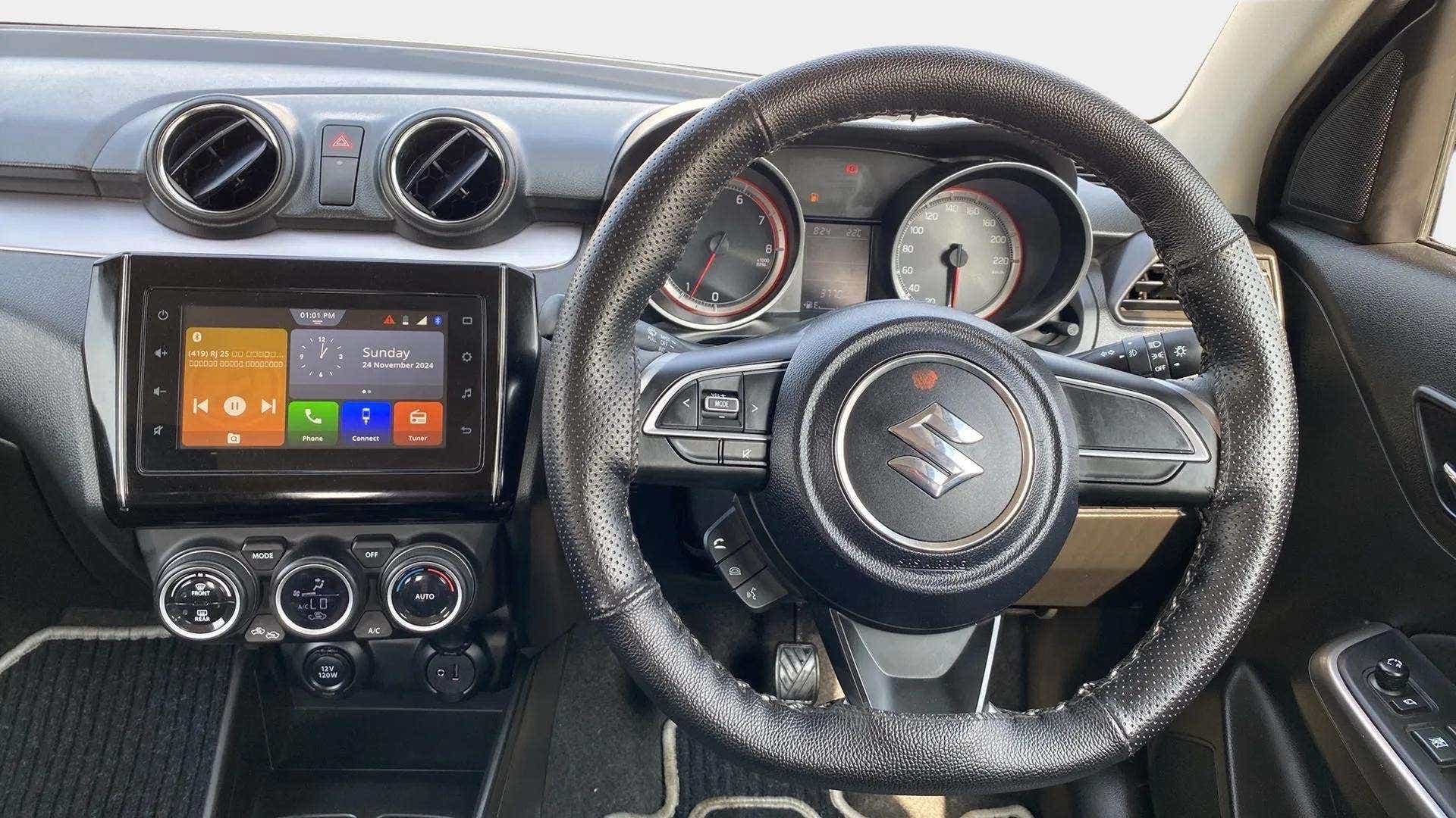 Interior dashboard and steering wheel of a Maruti Suzuki Swift