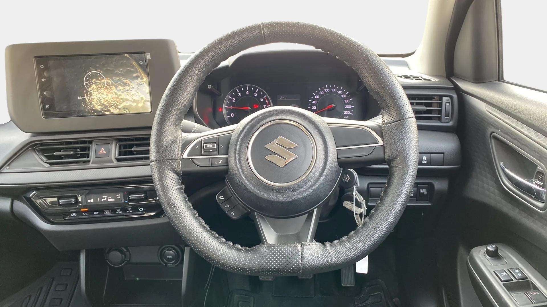 Interior dashboard and steering wheel of a Maruti Suzuki Swift