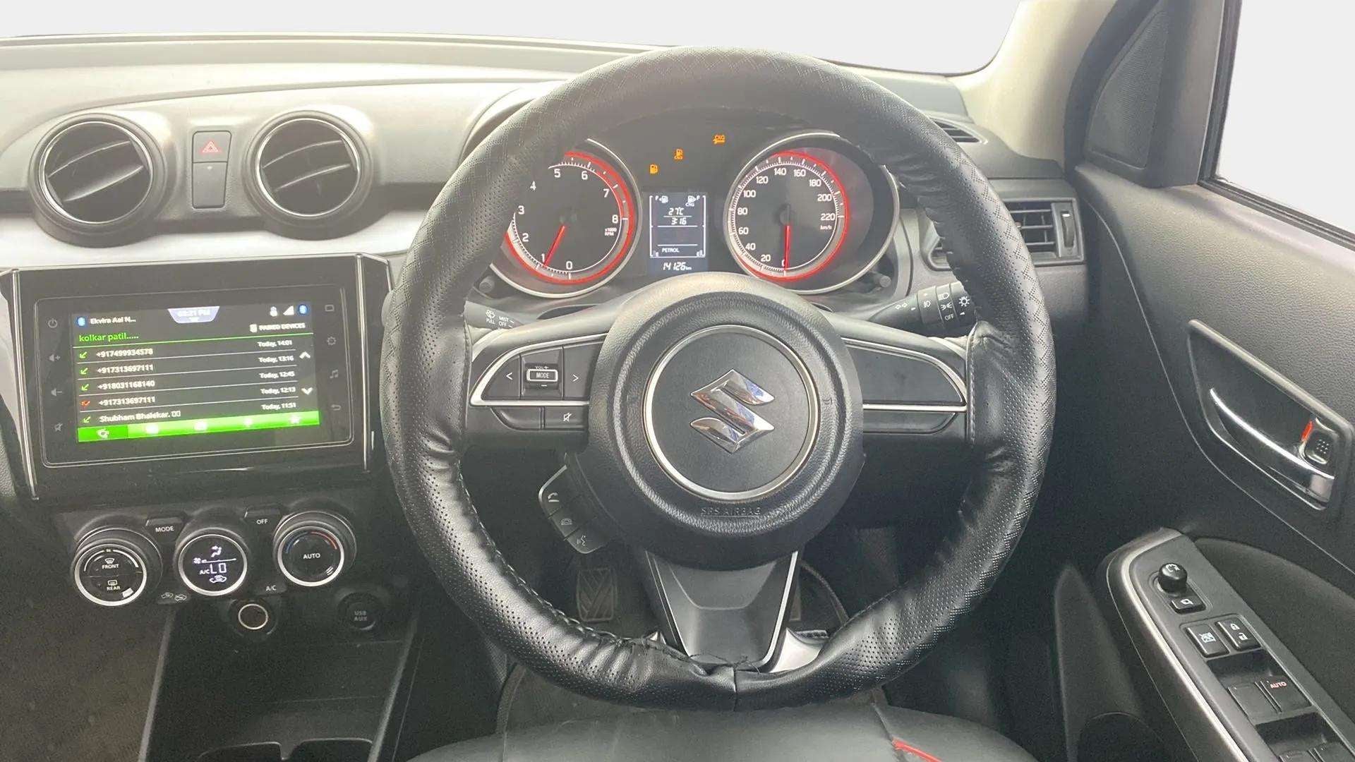 Interior dashboard and steering wheel of a maruti suzuki swift 2021 - 2023