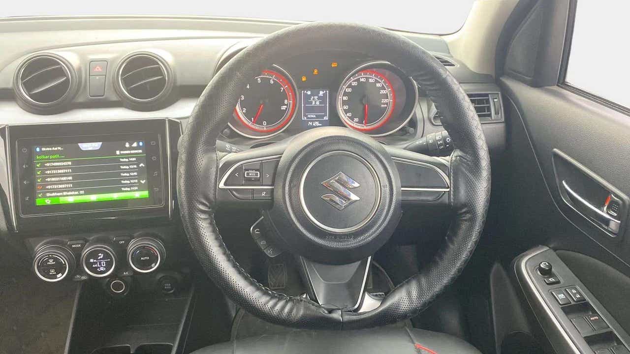 Interior dashboard and steering wheel of a maruti suzuki swift 2021 - 2023