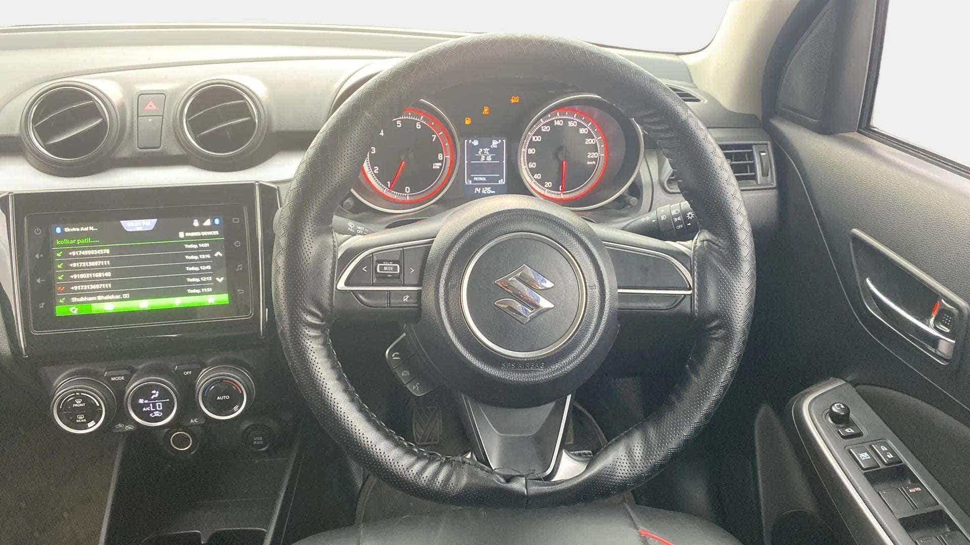 Interior dashboard and steering wheel of a maruti suzuki swift 2021 - 2023