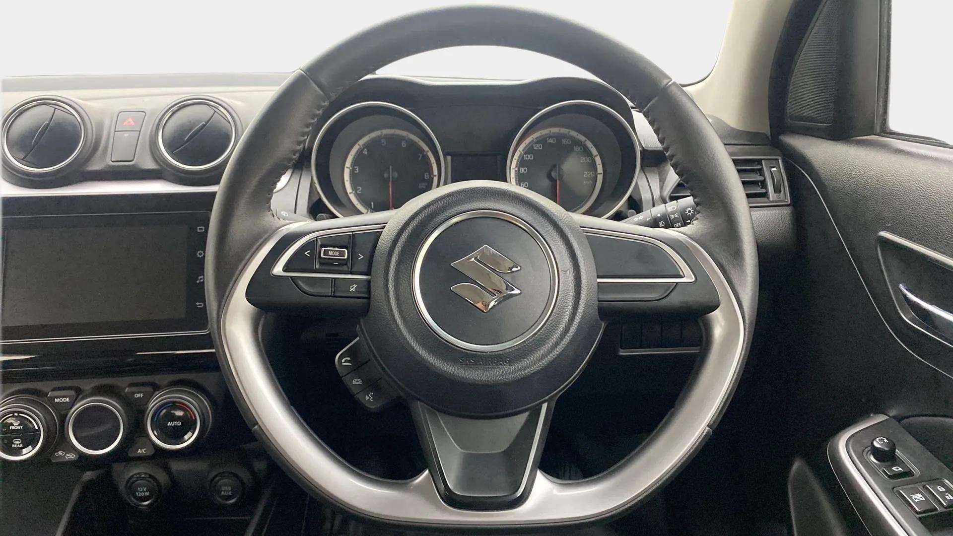 Interior dashboard and steering wheel of a Maruti Suzuki Swift 2021 - 2023