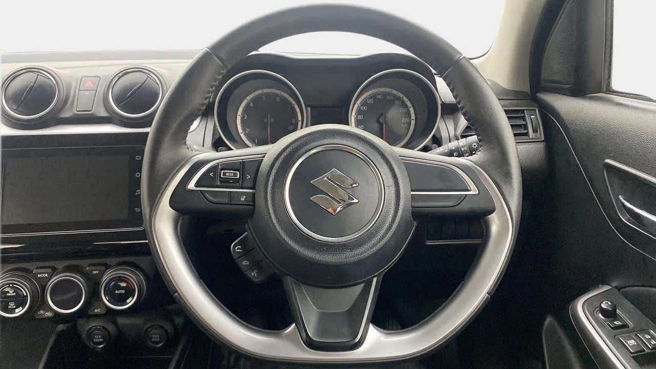 Interior dashboard and steering wheel of a Maruti Suzuki Swift 2021 - 2023
