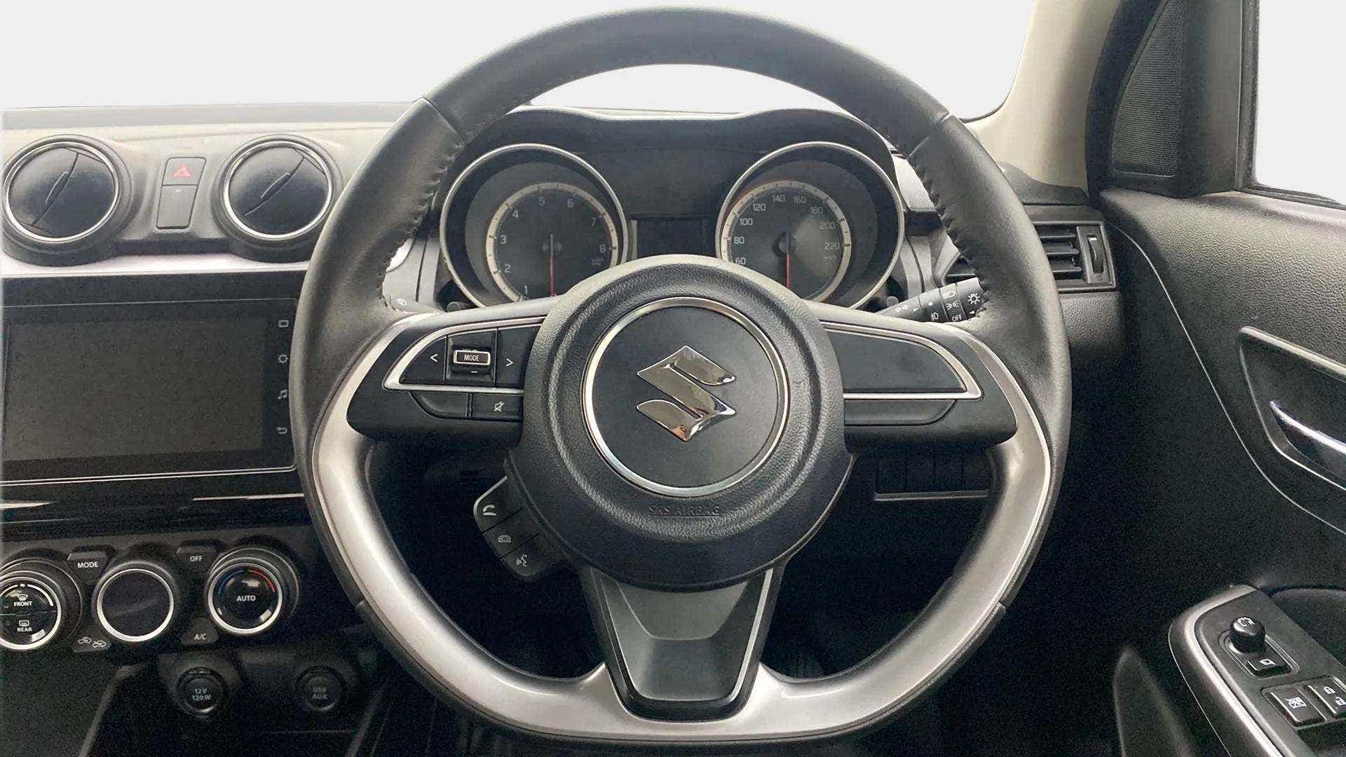 Interior dashboard and steering wheel of a Maruti Suzuki Swift 2021 - 2023