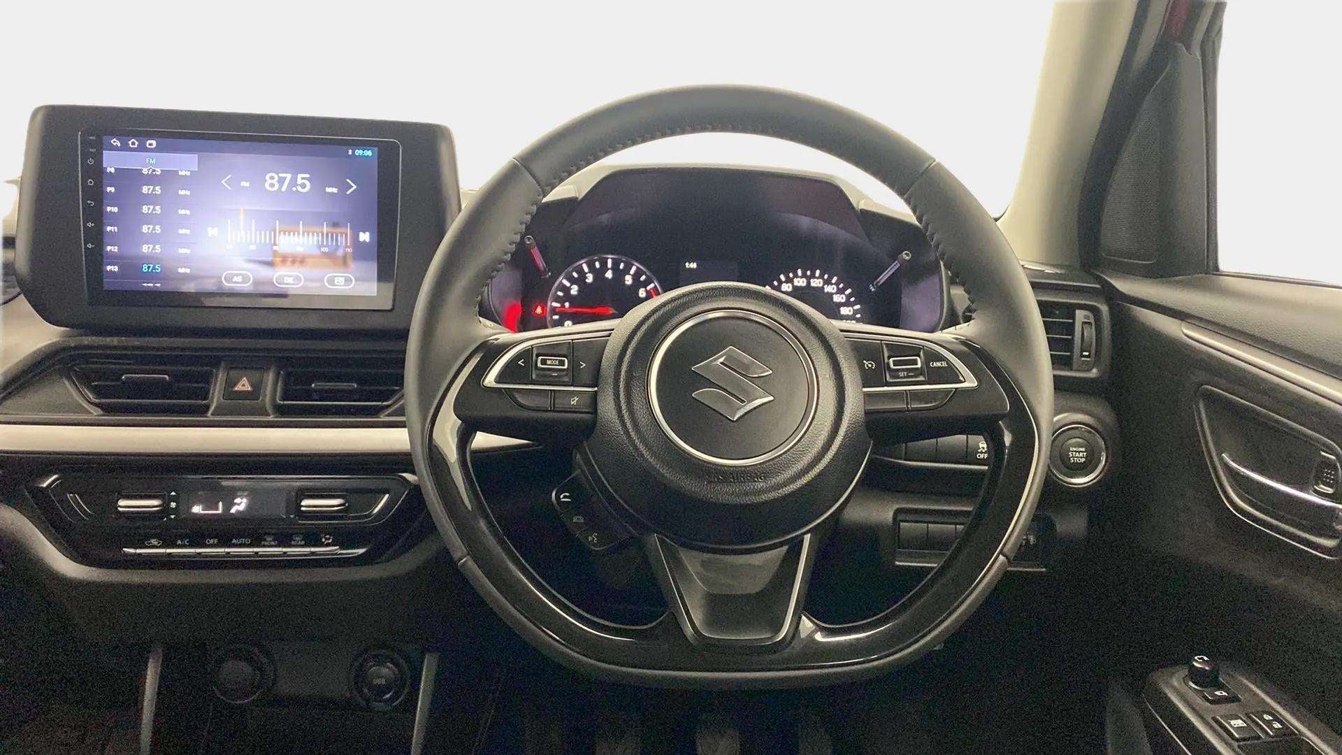 Dashboard and steering wheel of a Maruti Suzuki Swift