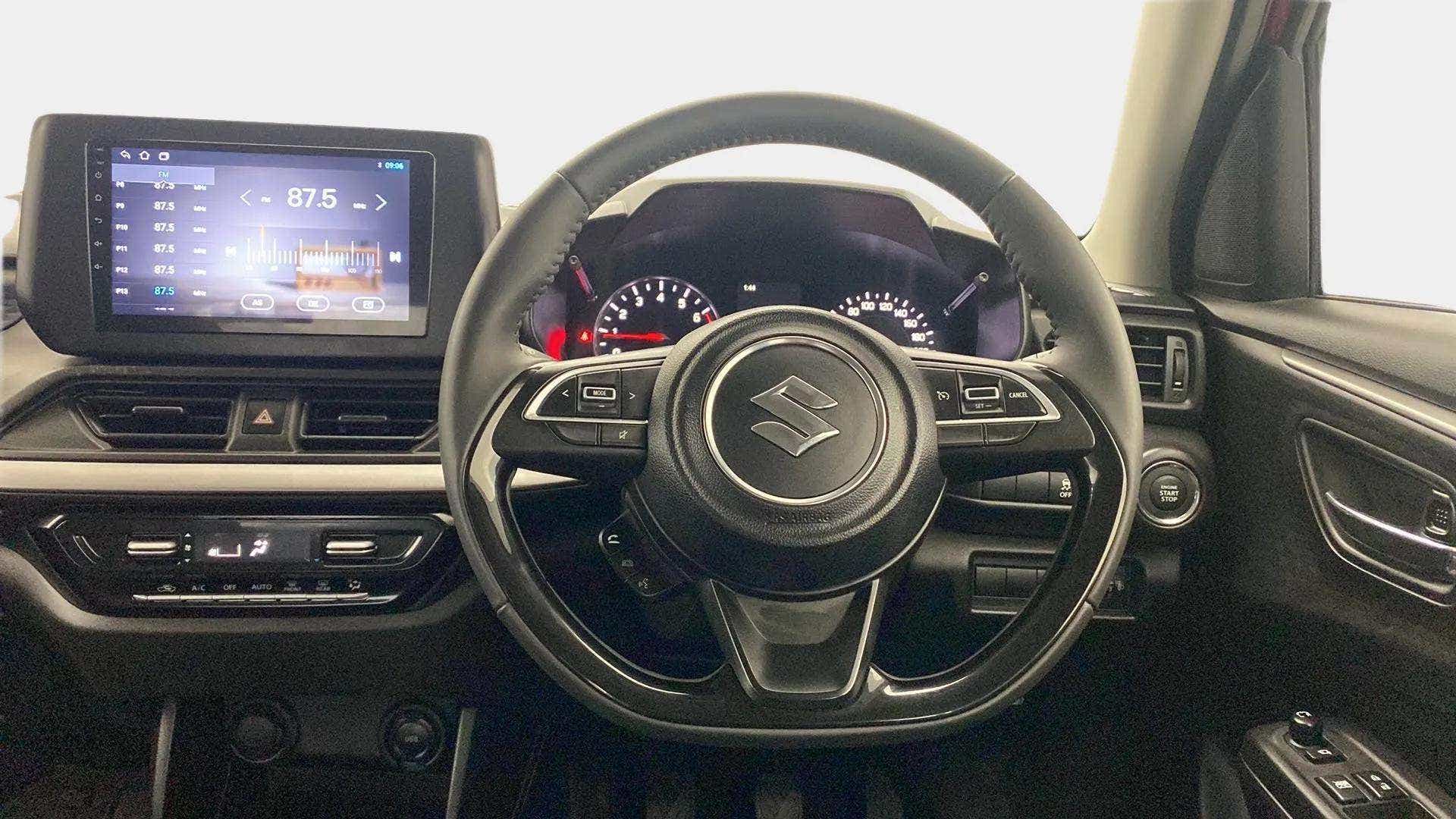 Dashboard and steering wheel of a Maruti Suzuki Swift