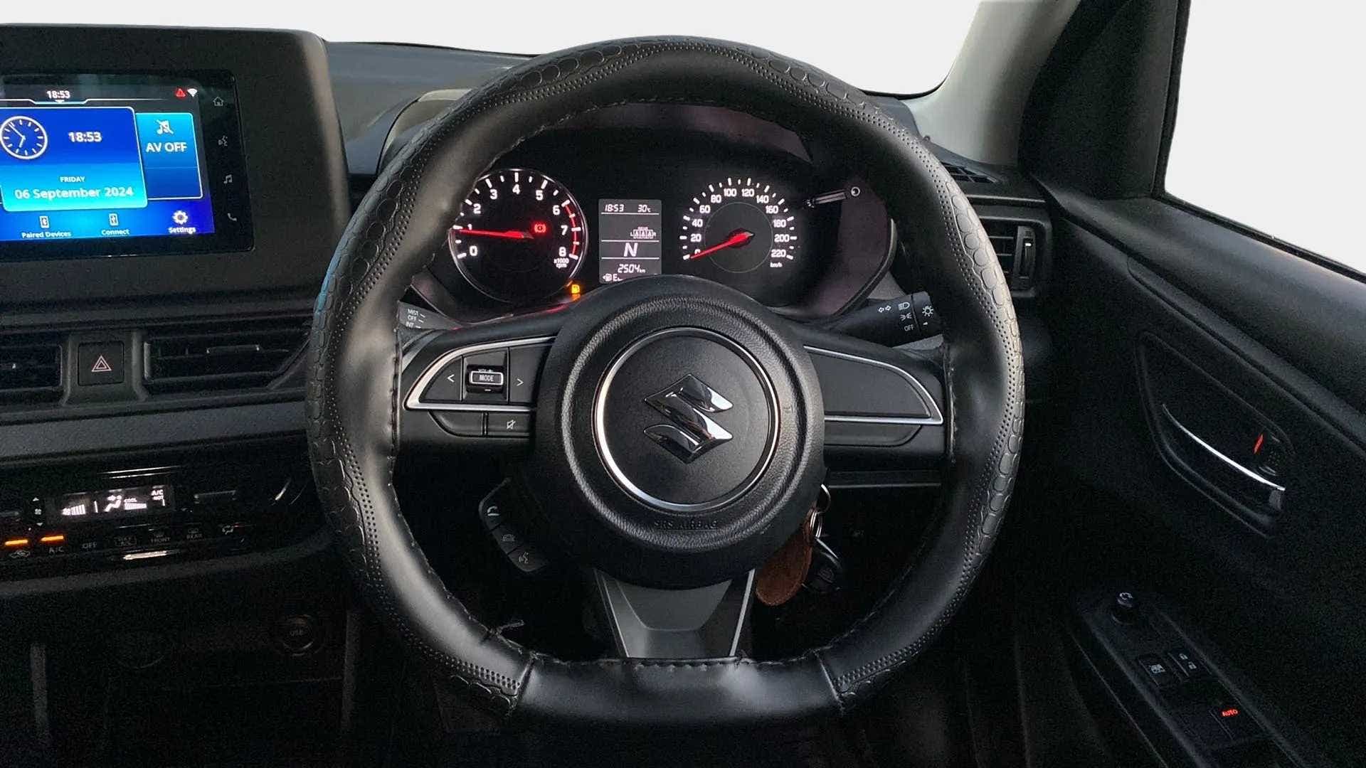 Steering wheel and dashboard of a Maruti Suzuki Swift