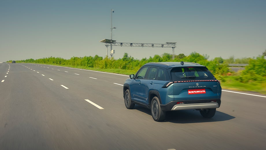 Rear three-quarter of a Eternal Blue Maruti Suzuki Victoris