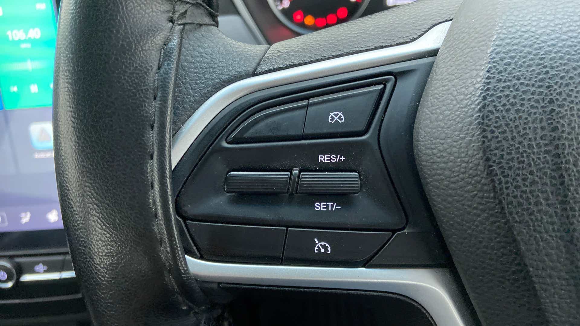 Steering wheel cruise control buttons of a MG Hector