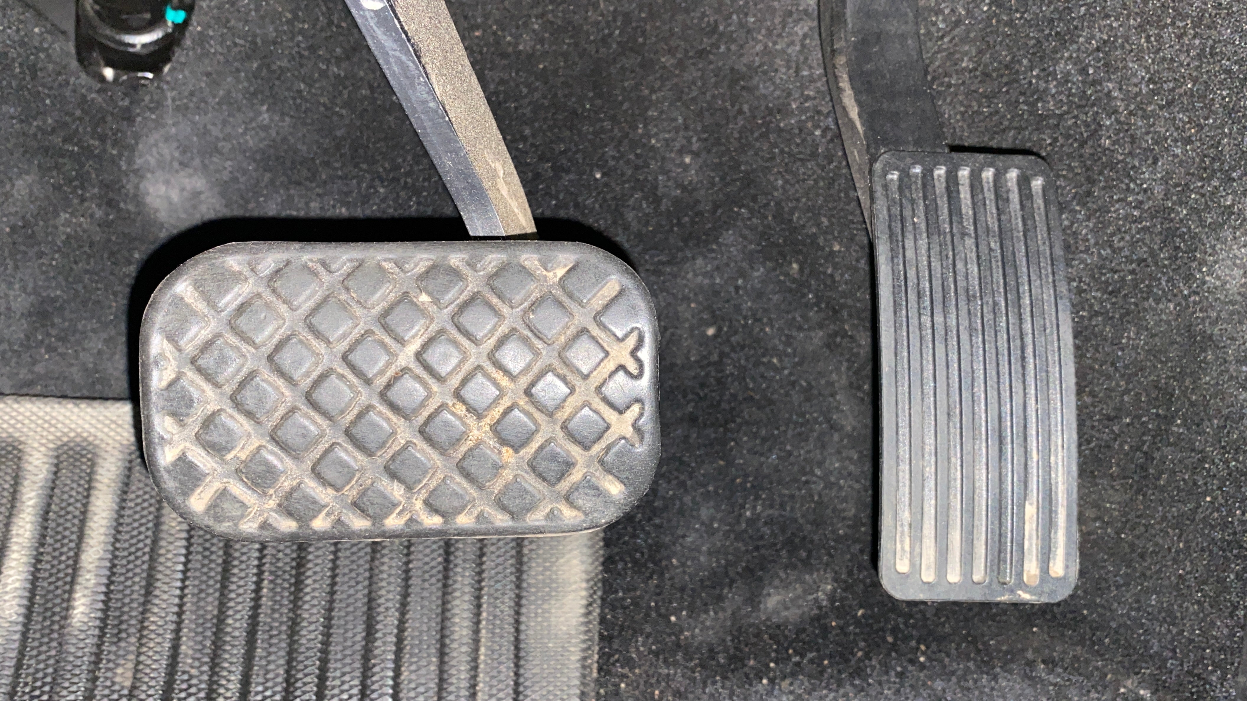 Close-up view of pedals in an MG Hector