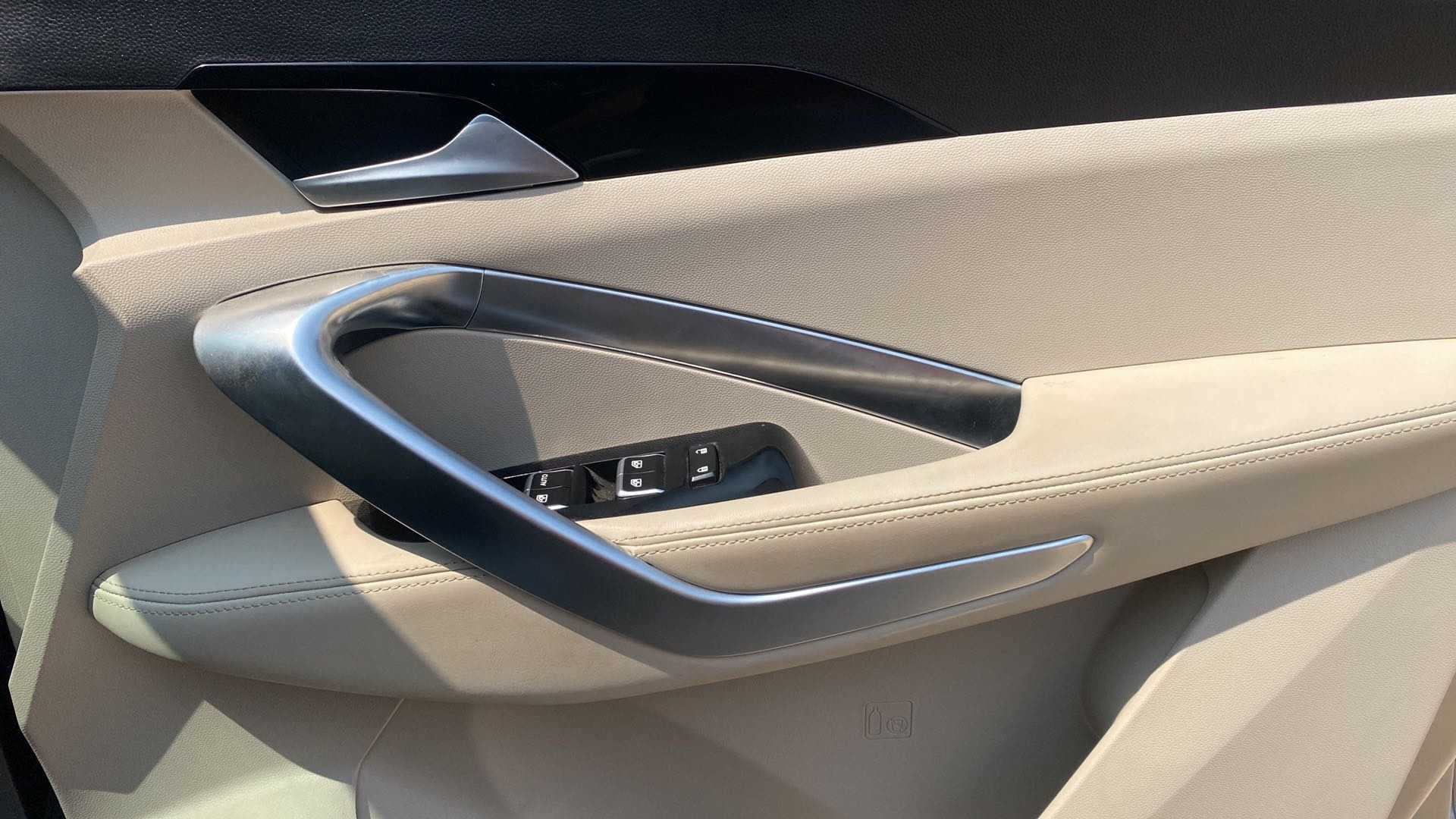 Interior driver-side door panel of a MG Hector