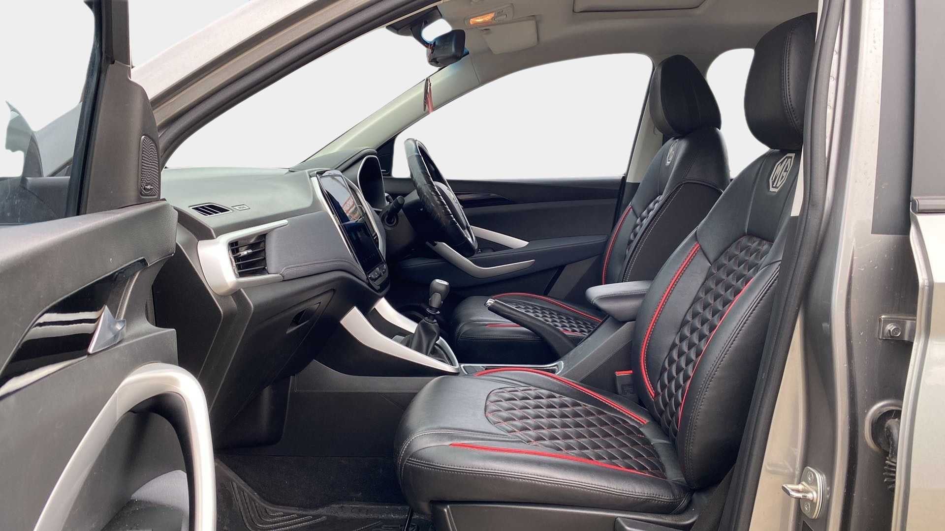 Interior front seats and dashboard of a MG Hector.