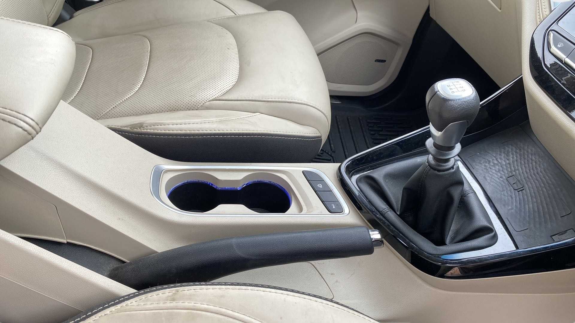 Interior gearshift and cup holder view of a MG Hector