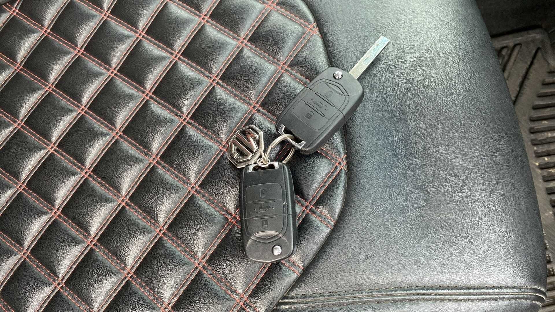Car keys and mg logo keychain on a leather seat of a mg hector