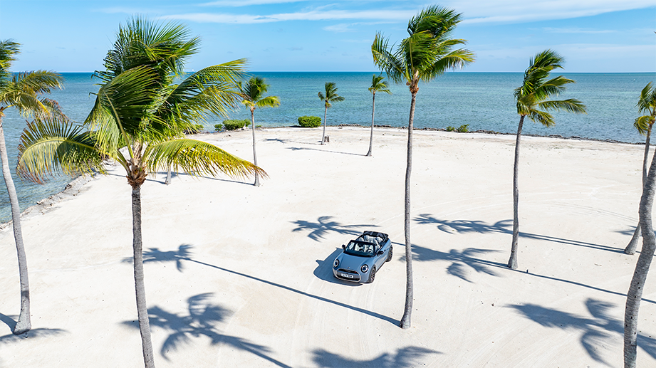 Overhead view of a Mini Cooper S Convertible parked on a sandy beach