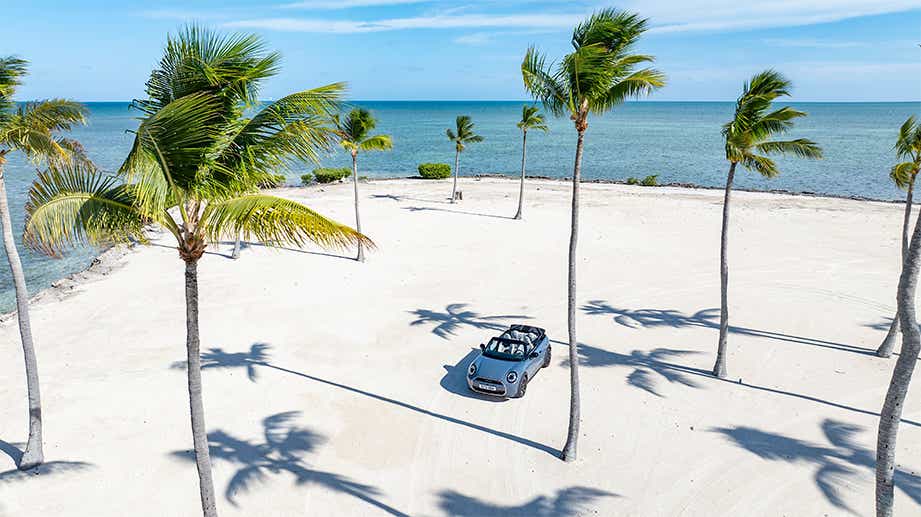 Overhead view of a Mini Cooper S Convertible parked on a sandy beach