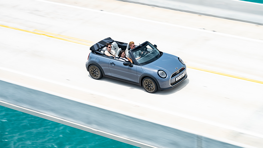 Overhead view of a Mini Cooper S Convertible driving on a bridge