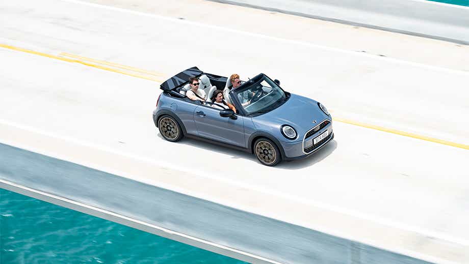 Overhead view of a Mini Cooper S Convertible driving on a bridge