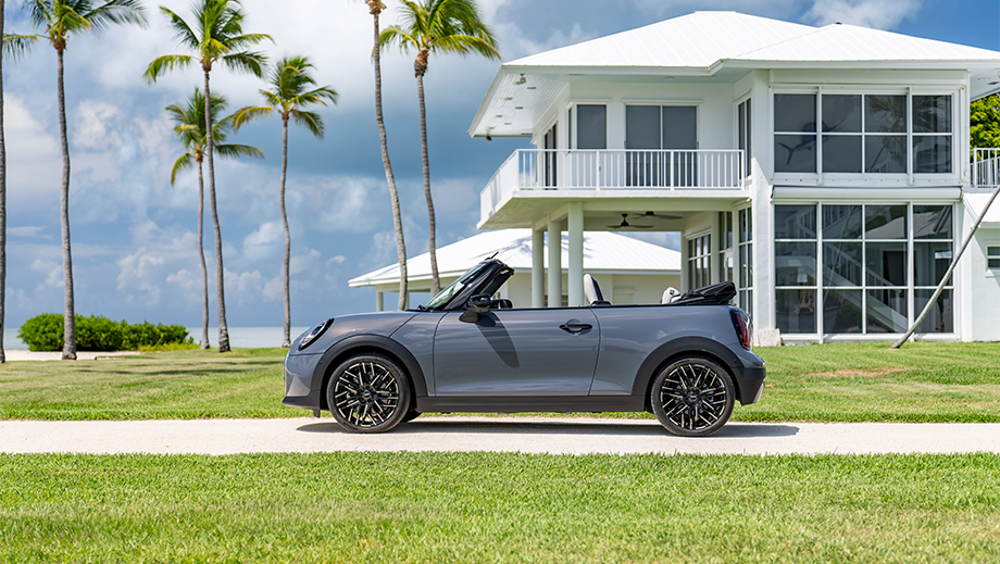Side view of a Mini Cooper S Convertible near a modern house