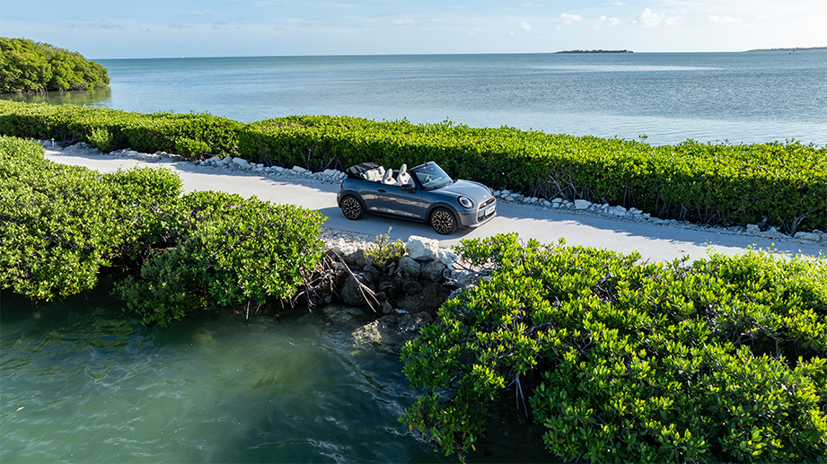 Full car view of a Mini Cooper S Convertible on a coastal road