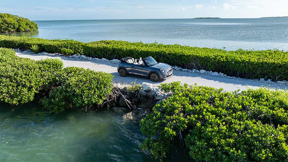 Full car view of a Mini Cooper S Convertible on a coastal road