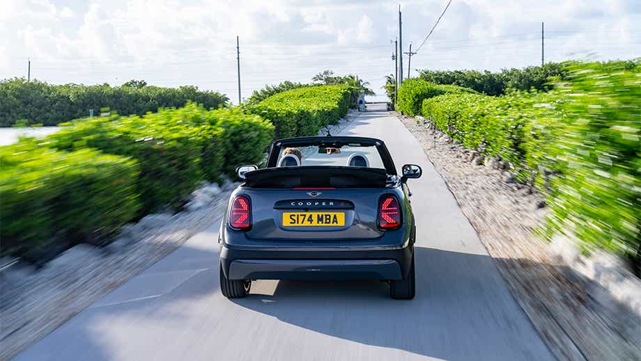 Rear view of a Mini Cooper S Convertible on a countryside road