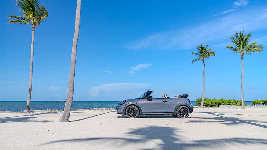 Side view of a Mini Cooper S Convertible on a beach