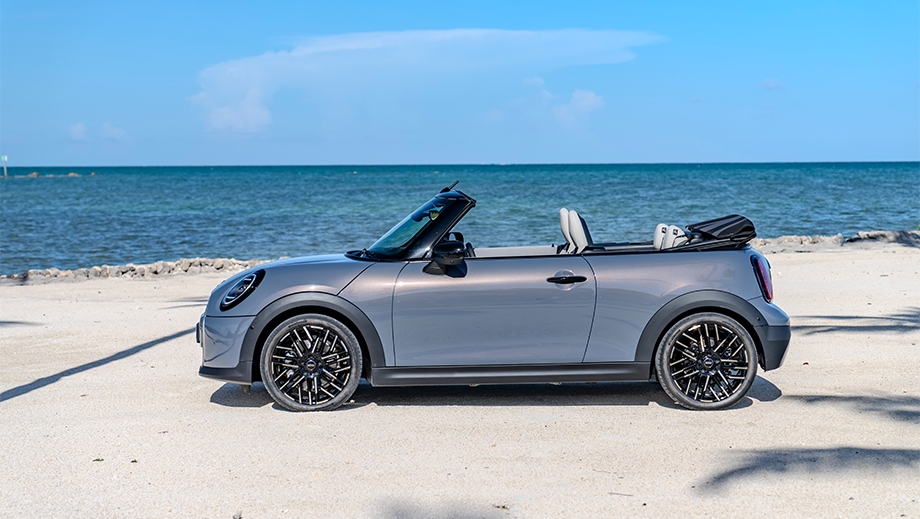 Side profile of a Mini Cooper S Convertible on a beach